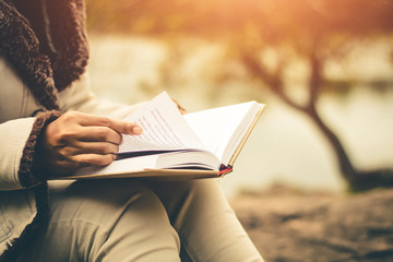 Women in winter sit read favorite book in the holiday, Concept girl reading a book.