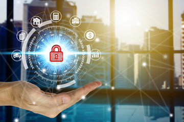 Businessman hand holding network using padlock over the Network connection technology