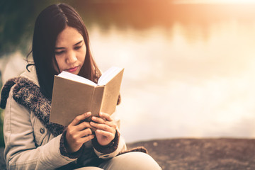 Fototapeta premium Women in winter sit read favorite book in the holiday, Concept girl reading a book.