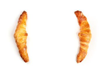 Two croissants on a white background, shot from the top, forming a frame for copy space
