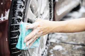 Man wash car using shampoo - every day life car care concept