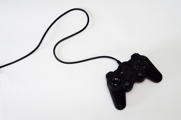 black game console lying on white background