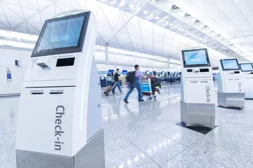 Deurstickers Self service machine and help desk kiosk at airport for check in, printing boarding pass or buying ticket © leeyiutung