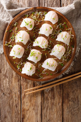 Chinese dim sum with shrimps served with microgreen close-up. Vertical top view