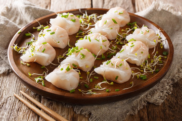 Homemade dumplings dim sum with filling of shrimps and sprouts close-up on a plate. horizontal