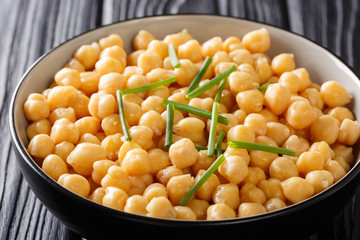 Healthy boiled chickpeas with green onions close-up in a bowl. horizontal