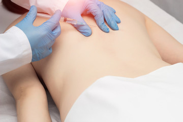 Doctor injects trigger points on the patient s back to eliminate muscle spasm and pain, lumbago