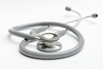 Gray stethoscope medical equipment on white canvas. instruments device for doctor. medicine concept