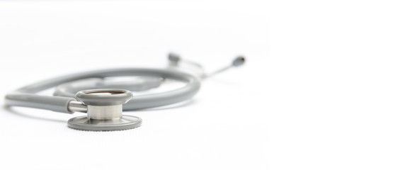 Gray stethoscope medical equipment on white canvas with copy space. instruments device for doctor. medicine concept