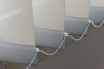 Modern vertical fabric blinds on the window in the office