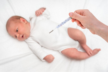 Measuring temperature to a newborn baby with mercury thermometer