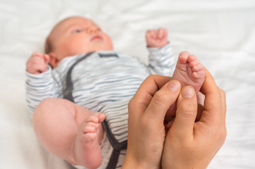 Mother makes foot massage for her baby © andriano_cz