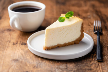 Cheesecake and cup of coffee on wooden table. Coffee and cake. Horizontal view - 243245532