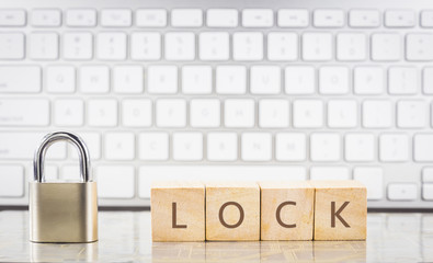 Close key with word LOCK on cubes, keyboard background.