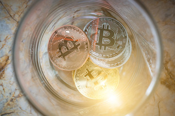 Top view of a dozen coins, Alternative investment in bit coin, Investor may learn saving money from coins, A studio photo of a money jar.