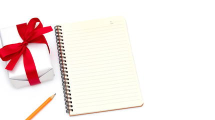 top view Gift box with notepad,pencil yellow placed on the desk isolated on white background