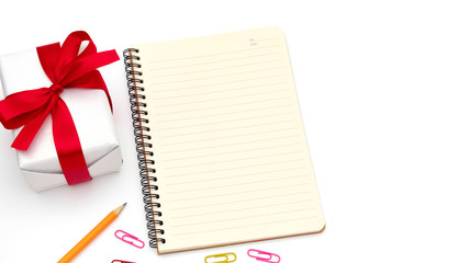 top view Gift box with notepad,pencil yellow,paper clip placed on the desk isolated on white background