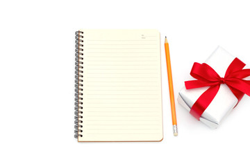 top view Gift box with notepad,pencil yellow placed on the desk isolated on white background