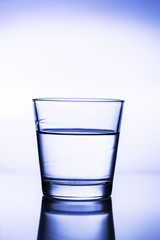 Splash ice cubes in a water glass