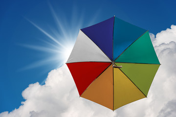 Multicolor umbrella flying in the sky