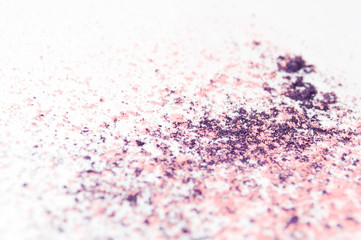 Fototapeta na wymiar crushed purple and pink eye shadow on white background 
