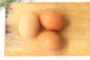 egg on a cutting board isolated on white 