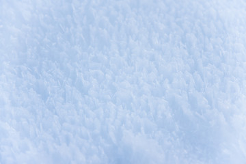 Fototapeta na wymiar Frozen snow surface. Close up
