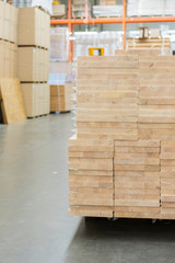 Pallet with boards in the hardware store. Packed boards in the building store. building materials. warehouse with variety of timber for construction and repair. vertical photo.