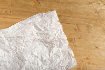 wrinkled paper on wooden background