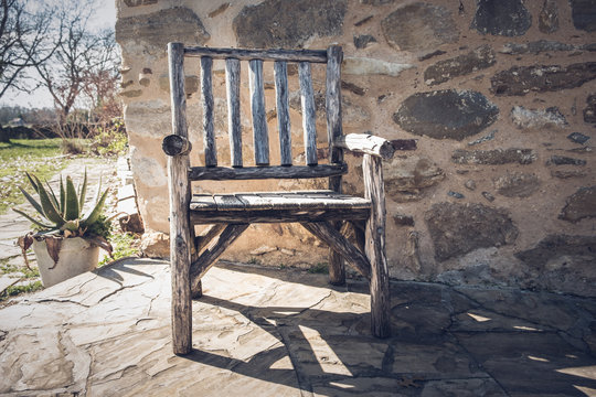 Empty rustic wooden chair outdoors at southern ranch on a sunny day