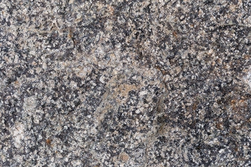 a fragment of a small area granite tiles as a background