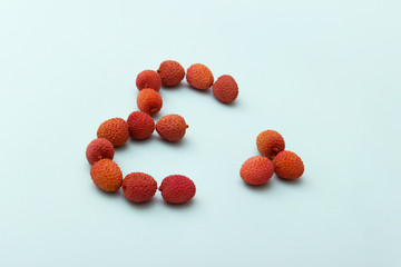 Red lychee heart shape on blue White Background.Valentines Day symbol Made of Red lychee