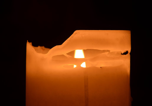 Burning vandle where the houer perimeter has melted into an abstract mask..