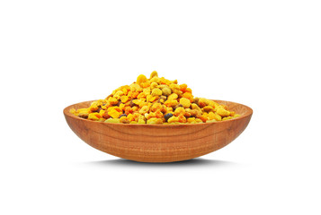 bee pollen and wooden bowl isolated on a white background