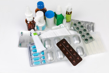 Different types of various medicines packaging on a white table