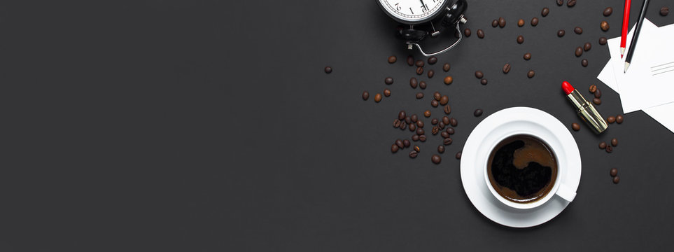 Flat lay cup of black coffee and coffee beans on gray dark background top view copy space. Minimalistic food concept, morning breakfast, time to work, hot drink, coffee background
