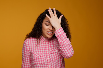 Regrets wrong doing. Closeup portrait silly young woman, slapping hand on head having duh moment...