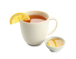 Cup of hot tea with lemon and honey on white background