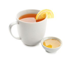 Cup of hot tea with lemon and honey on white background