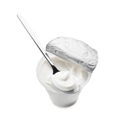 Plastic cup of tasty yogurt and spoon on white background