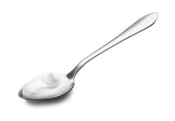 Spoon with tasty yogurt on white background