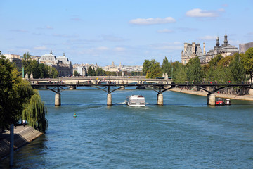 white boat crosses the Seine in Paris