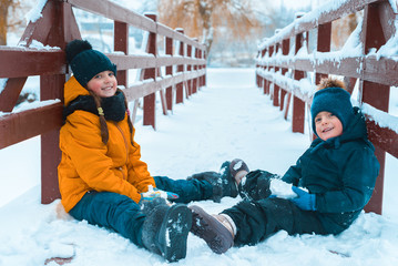 Fototapeta na wymiar portrait of little cute boy and beautiful girl. brother and sister smiling together. winter