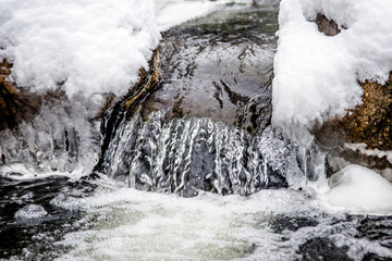 A small waterfall on the river in the winter Park 