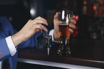 Fototapeta na wymiar Do not drink and drive! Cropped image of drunk man talking car keys