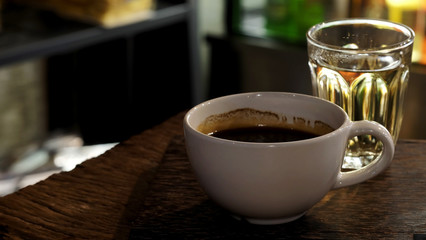 Well mixed black hot black coffee in white coffee cup on wood table served in a restaurant in a coffee break time, popular drink for meeting place and party time, value added design for better sales