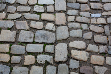 Wet cobbled stone sidewalk after the rain in historical center in old city