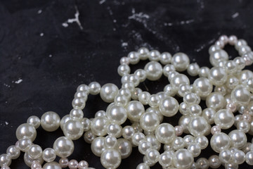 white pearl beads on black background,