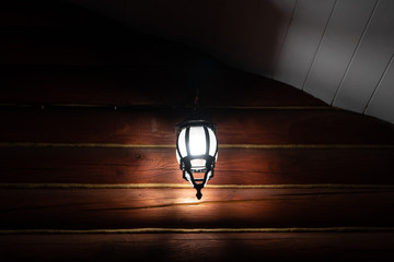 street lamp on the wall of a shed country house