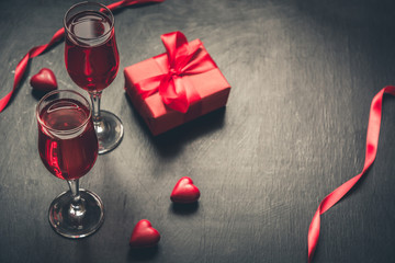 Valentine's card with champagne and heart candy on black.